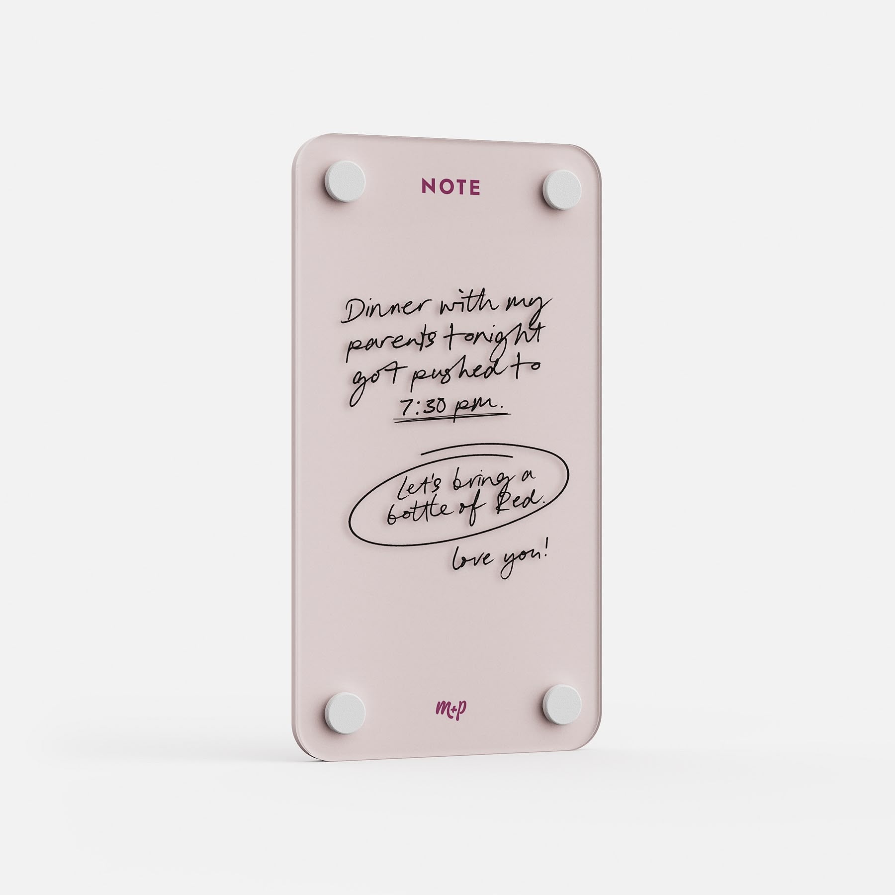 Angled view of a Linen white tall magnetic acrylic note board with a handwritten note to a partner